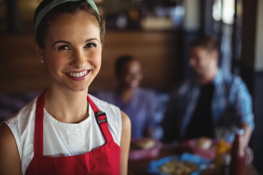smiling waitress with red apron